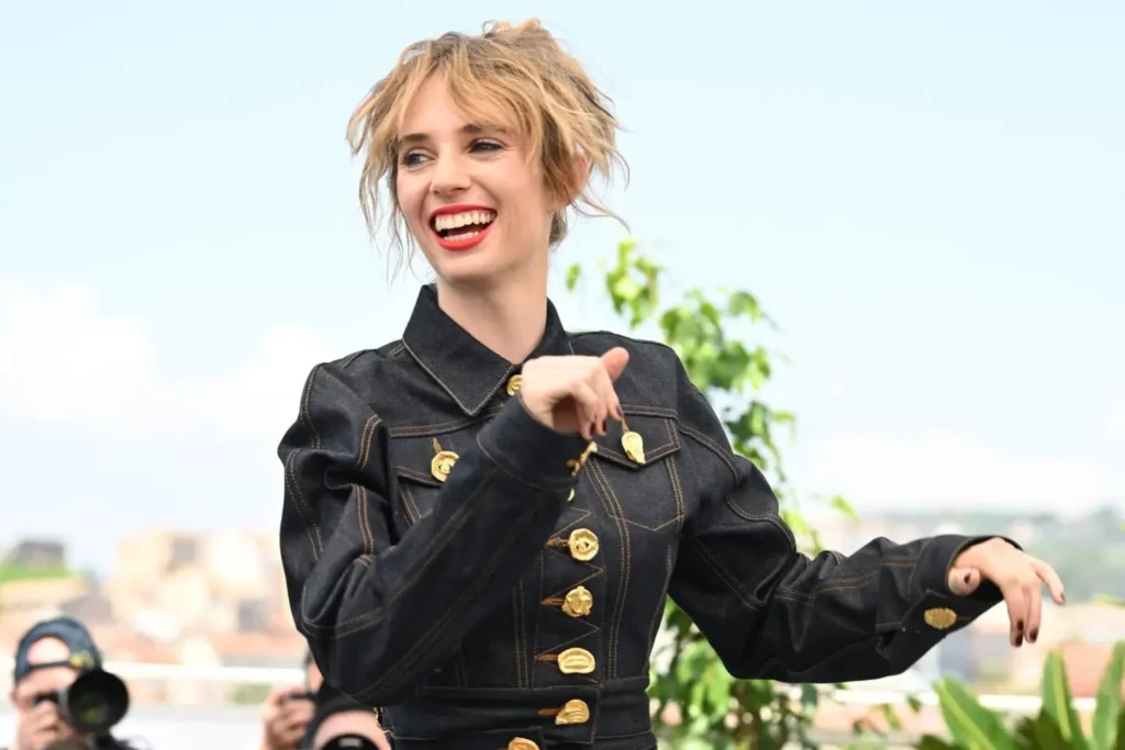 Maya Hawke, daughter of Uma Thurman and Ethan Hawke, walks the red carpet at a glamorous event, highlighting her Hollywood lineage and connections.