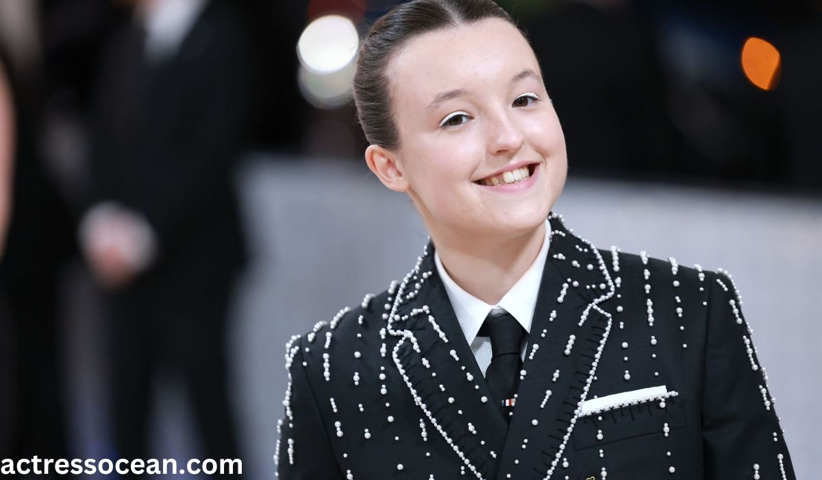 Bella Ramsey, talented English actress, smiling confidently during a red carpet event, showcasing her charismatic presence.